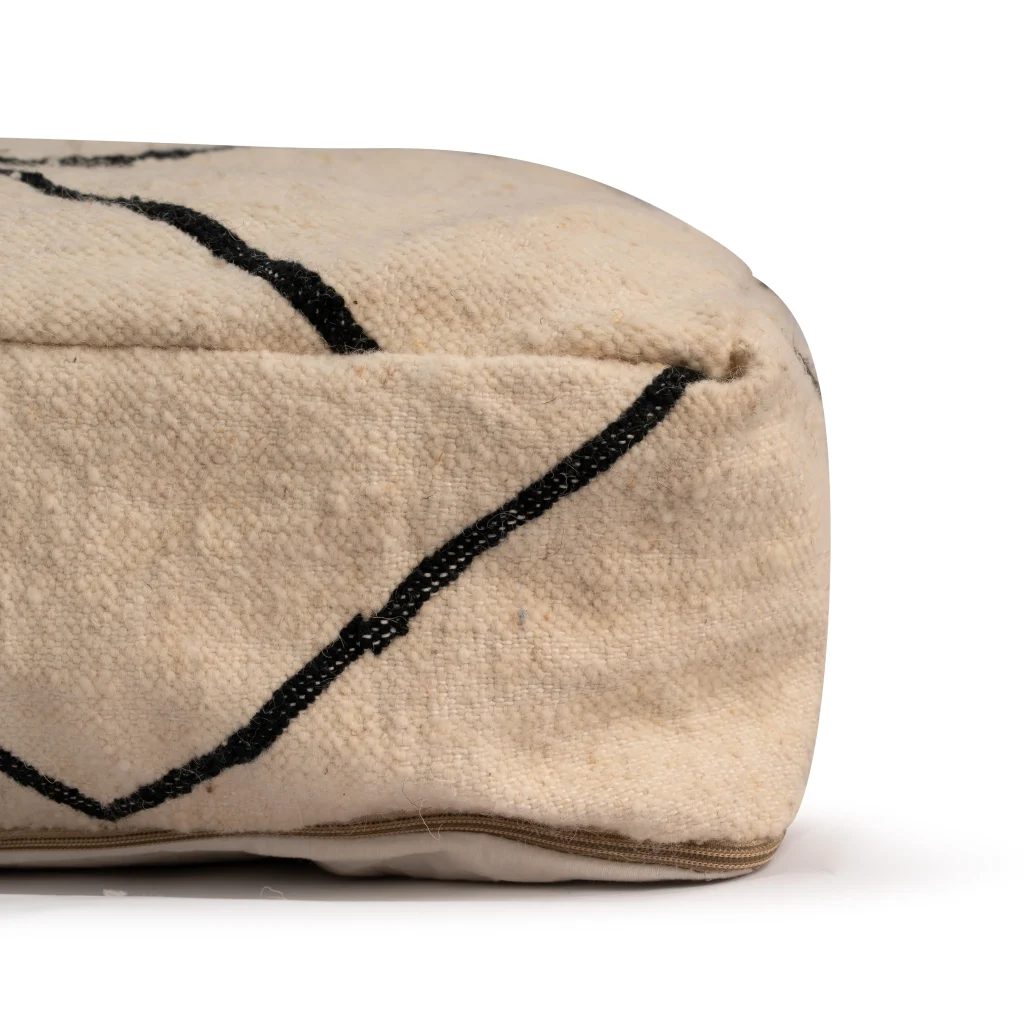 Discover our square Moroccan leather pouf crafted from vintage wool rugs with black diamond Berber motifs. Perfect as a leather pouf ottoman or floor cushion. Ships unstuffed.