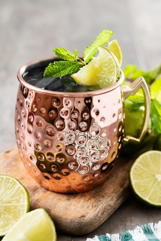 Moroccan Mint Tea and Apple Cider Moscow Mule cocktail on wooden table