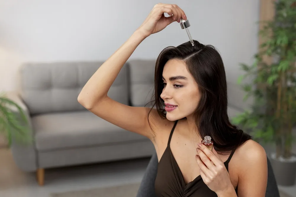 woman doing herself scalp massage with argan oil