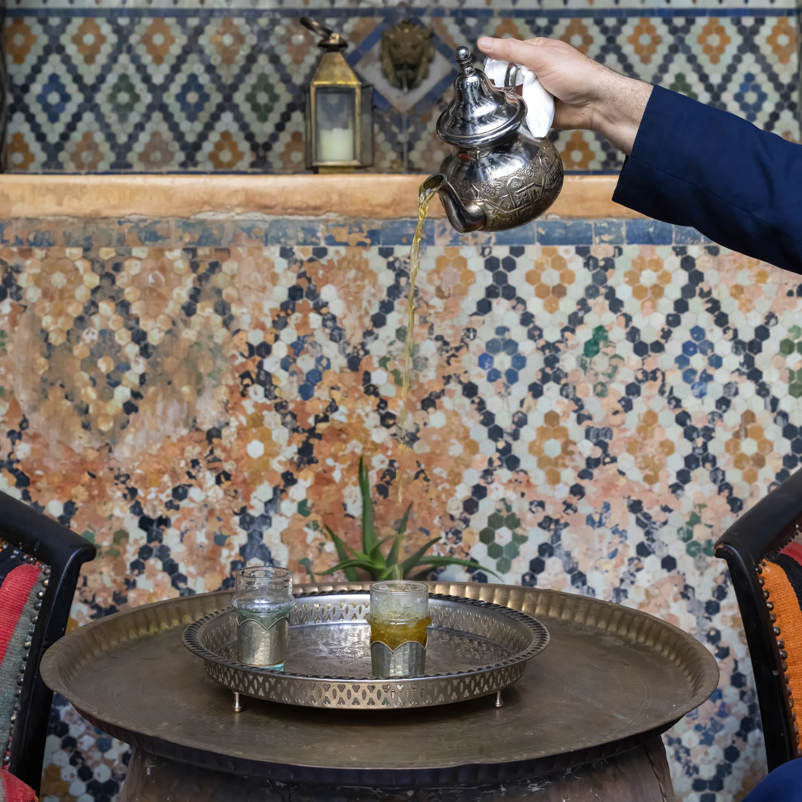 Moroccan serving Moroccan mint tea in the traditional way, Marrakech