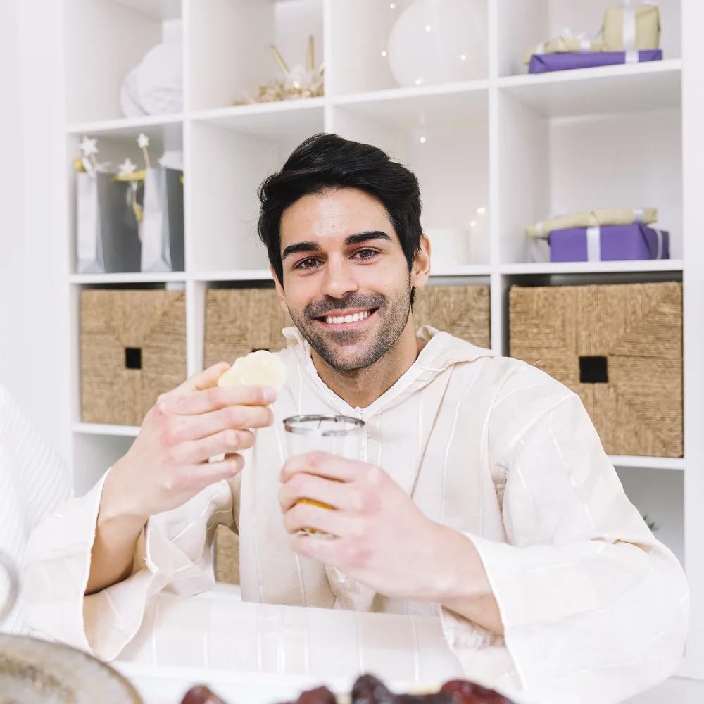 eid-al-fitr-concept-with-smiling-man-drikning-moroccan-mint-tea