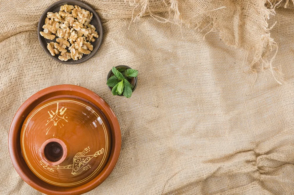 Moroccan Tagine next to a cup of Moroccan mint tea